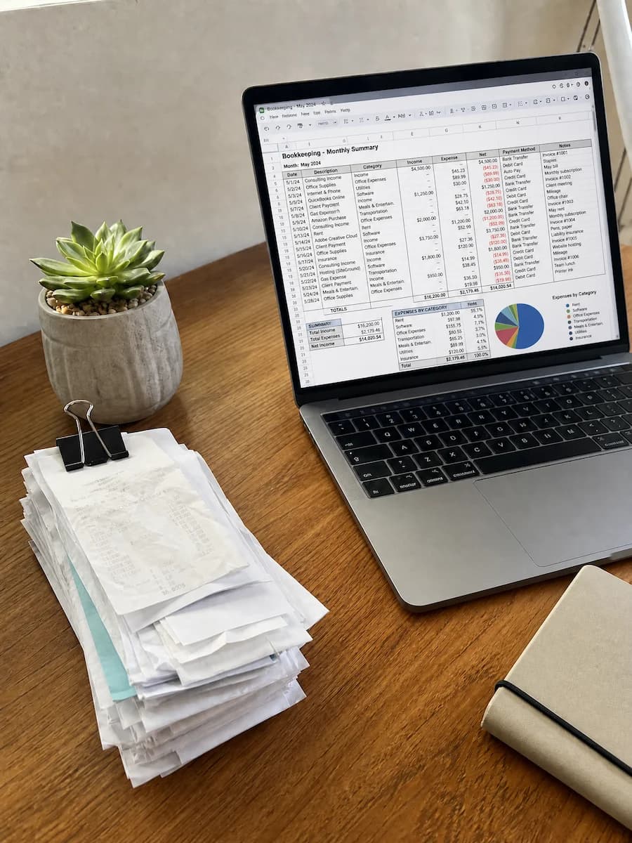 Organized financial documents and a calculator on a wooden desk